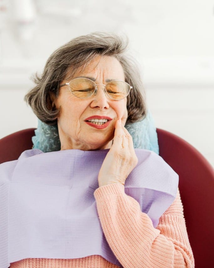 Dentist examining a patient's tooth for pain at Ooi Dan Rakan
